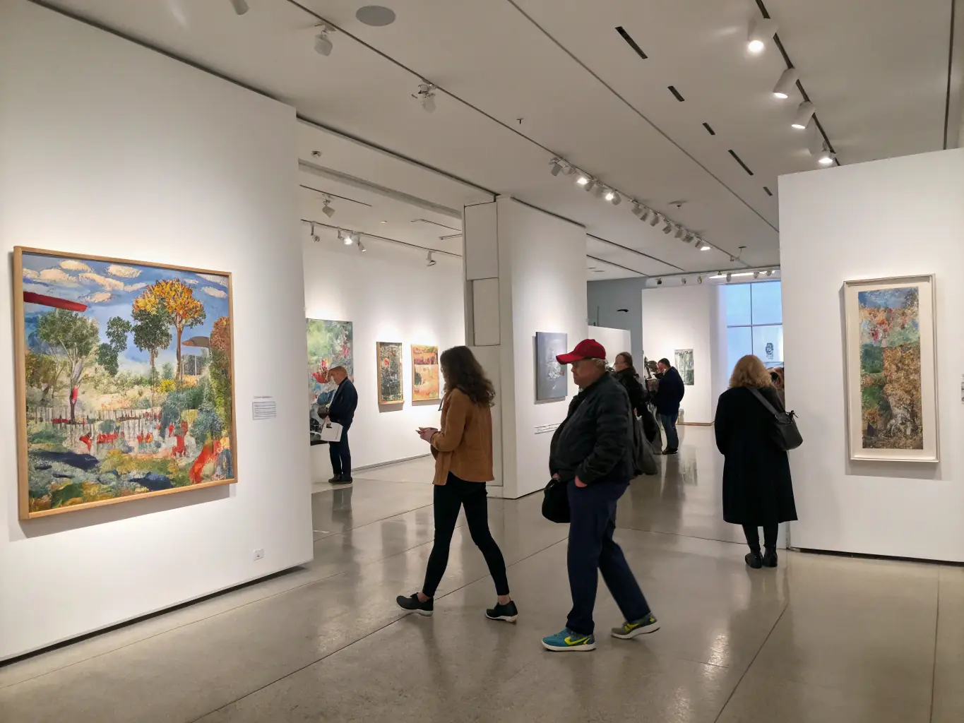 A photograph of an art exhibition hosted by DEVIATION 88, displaying various artworks with visitors admiring the pieces in a gallery setting.